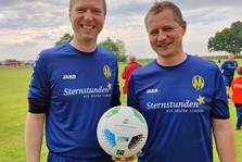 Im Rahmen des Sternstunden-Benefizfußballspiels beim ASV Nemmersdorf überreicht Landrat Florian Wiedemann einen fairen Landkreis-Fußball an den Goldkronacher Bürgermeister Holger Bär.